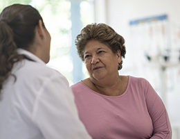 An older woman talking to her doctor.