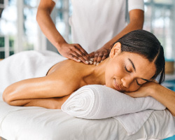 Woman laying on her stomach while receiving a massage.