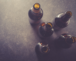 Four empty beer bottles photographed from above